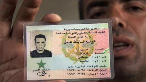Hussein Harmoush showing his military ID in a refugee camp in the Turkish town. Source: Facebook.