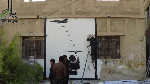 Artists work on the biggest graffiti on a wall in Yalda. Picture shared by the artists on Facebook
