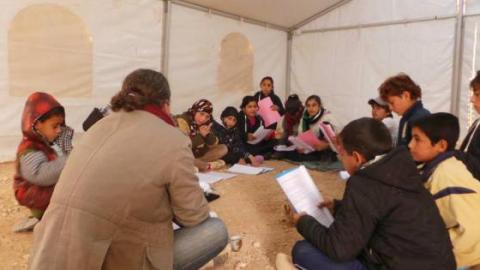Children study their scripts in the Shakespeare in Zaatari tent. Source: Shakespeare in Zaatari's facebook page