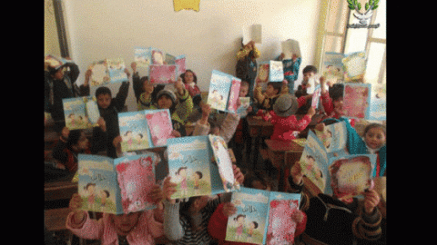 Children show their notebooks during one of the classes at the Olive Branch center. Source: Olive Branch's facebook page