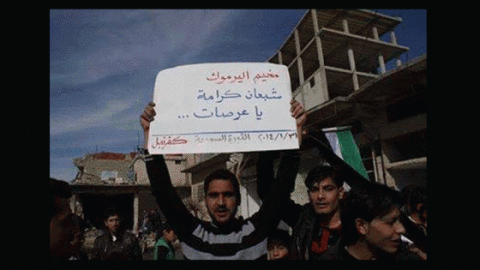 Kafranbel stands in solidarity with Yarmouk, with a banner that reads: Yarmouk's stomachs are filled with dignity, you bastards. Source: The We Want to Live campaign's Facebook page