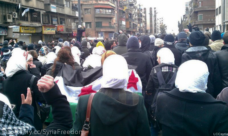 [Photo: Syrian women participate to a "revolutionary" funeral march in Mezzeh - Damascus - 19-2-2012. (Freedom House/CC BY-2.0)].