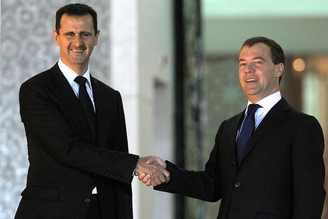 [Photo: Bashar al-Asad with Russian Prime Minister Dmitry Medvedev - Syria - 10-5-2010 (Kremlin.ru/CC BY 4.0 via Wikimedia Commons)].