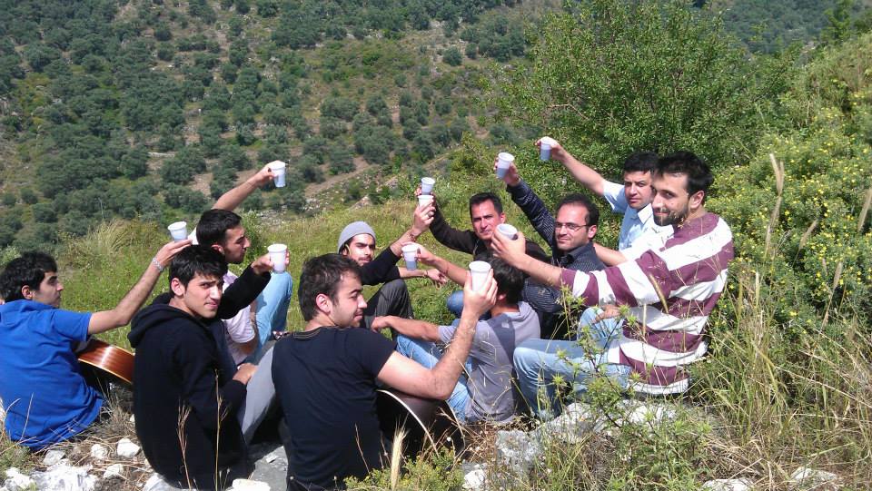 [Photo: Suleiman’s friends toasting in his memory, one year after his death. (SyriaUntold)].